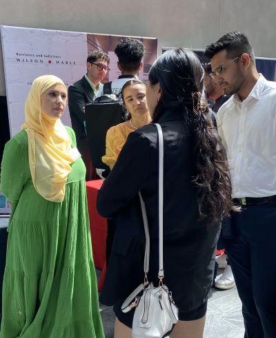 A group of people talking at the AUT Business Career Expo
